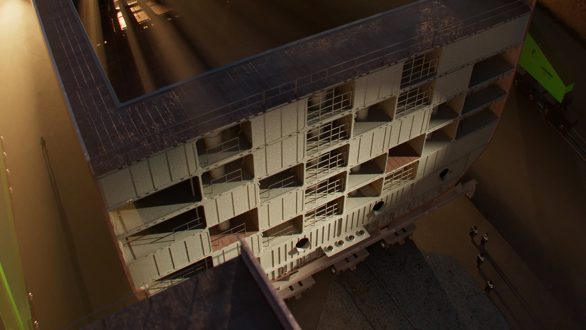 Overhead rendering of a multi-deck hull block on a transporter inside an assembly hall