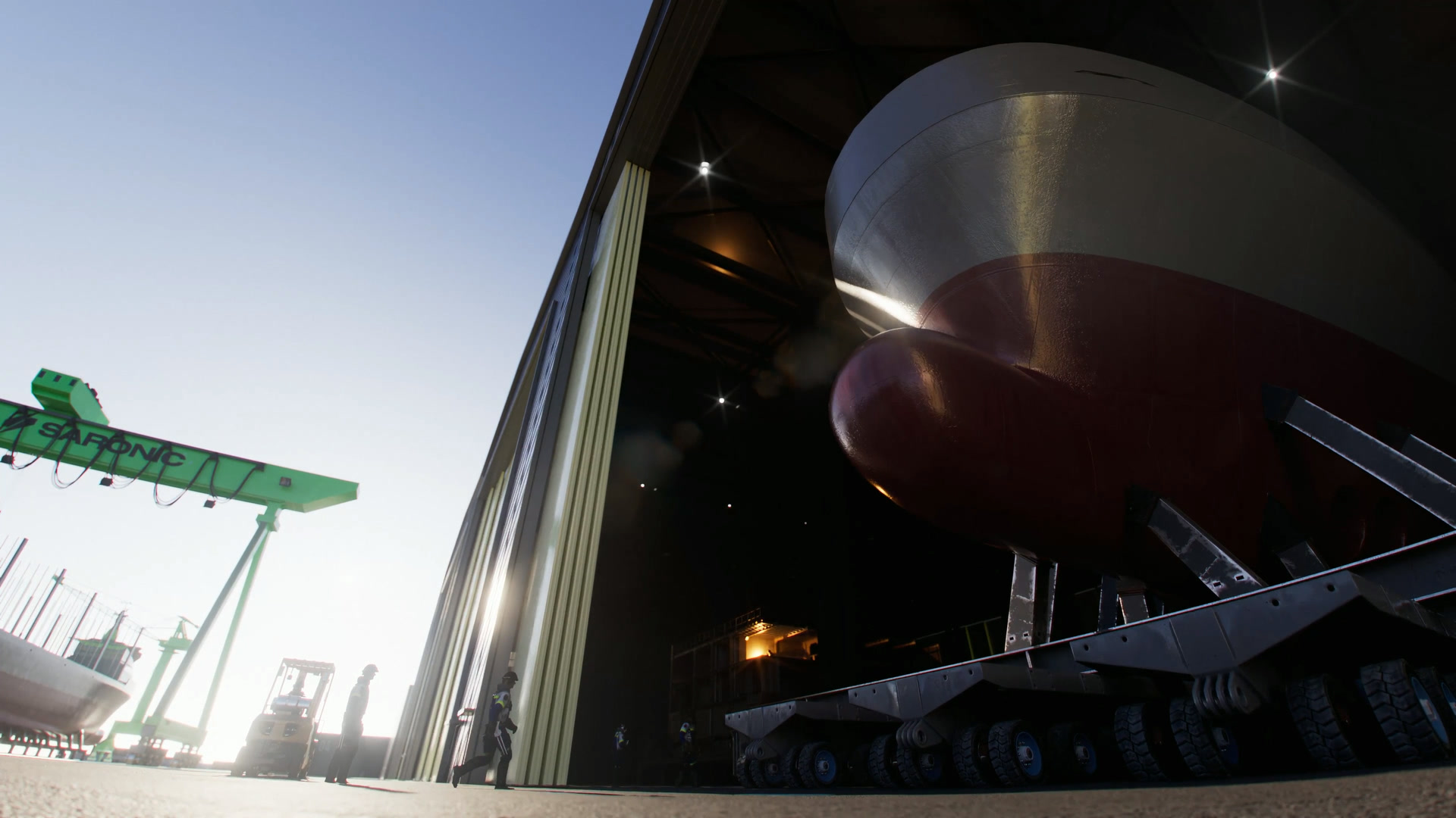 Low-angle rendering of a hull rolling out of a Port Alpha hall toward the gantry crane